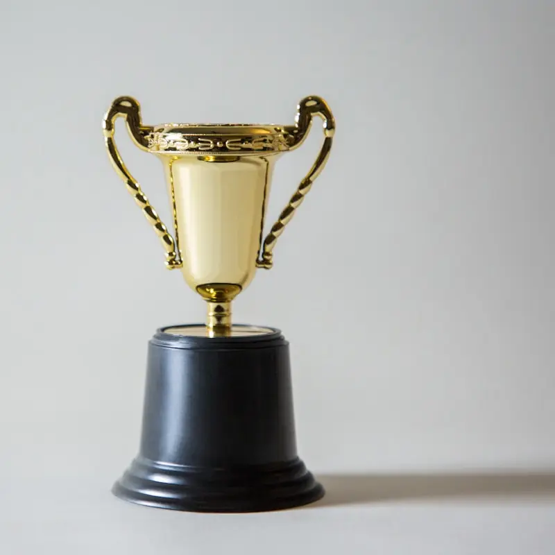 A gold trophy on a neutral background