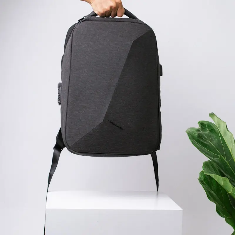 A laptop backpack displayed on a white plinth
