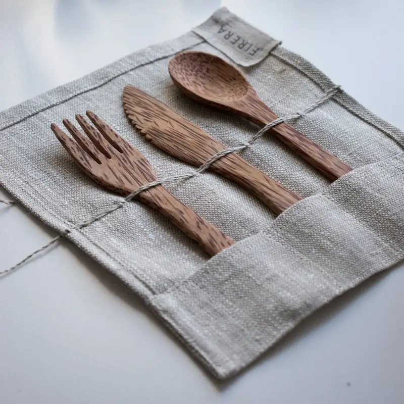 Wooden cutlery set on a linen roll
